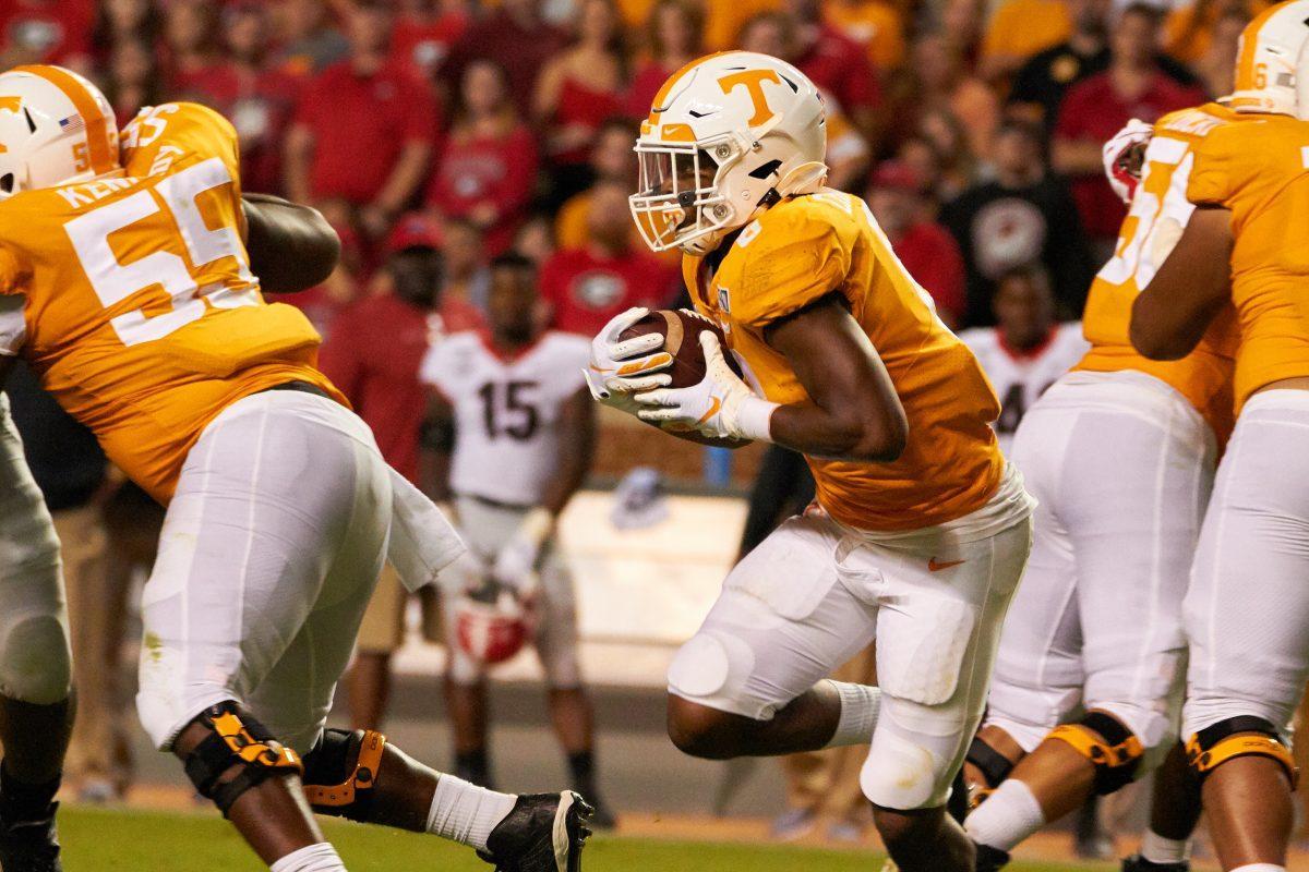 Ty Chandler, #8, charges through Georgia's defensive line at the Georgia SEC football game at Neyland Stadium on Saturday, October 5, 2019. 