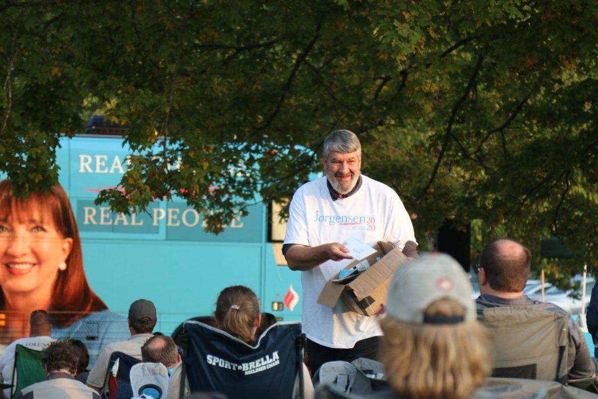 A volunteer for Jo Jorgensen's campaign passes out flyers at her rally at Lakeshore Park on Monday, October 19th, 2020.