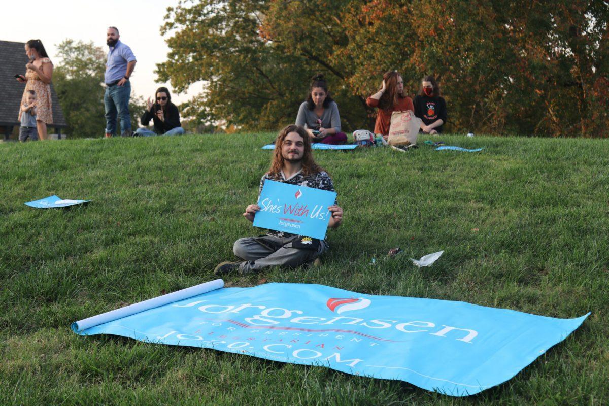A supporter of Jo Jorgensen poses with signs at Lakeshore Park on Monday, October 19th, 2020.