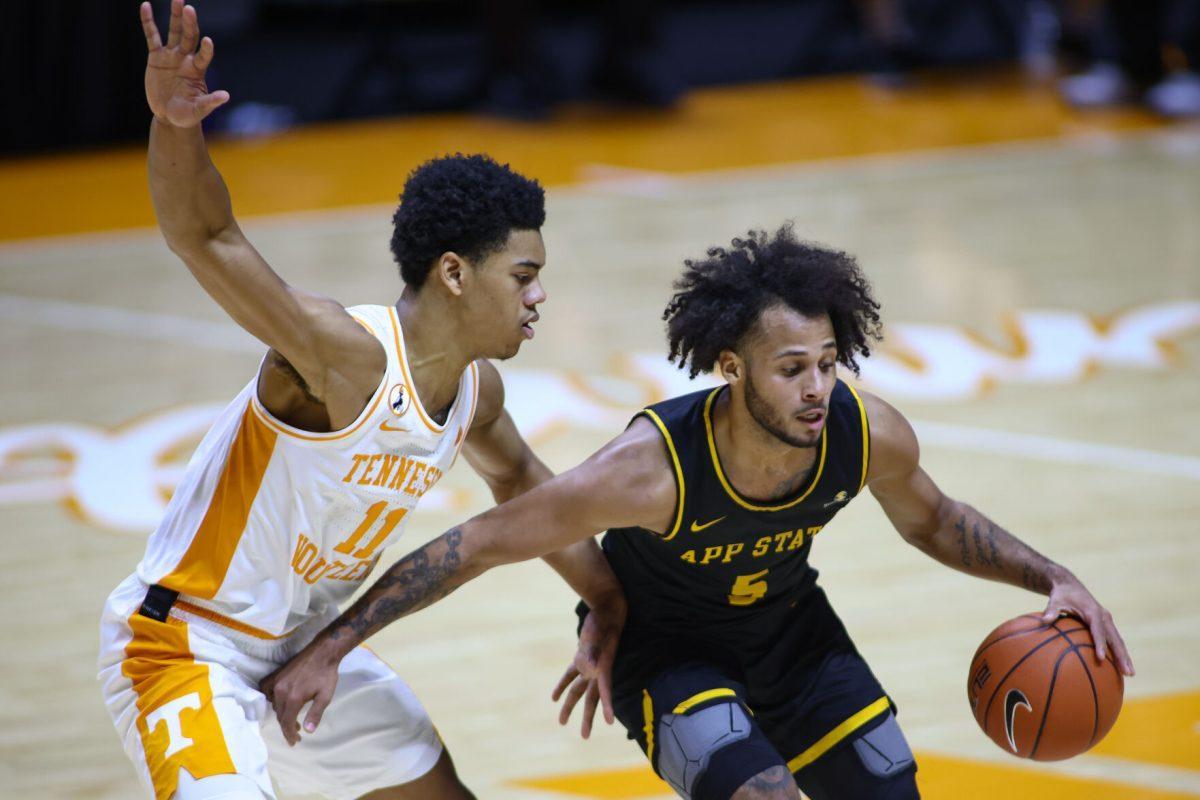 Dec 15, 2020; Knoxville, Tennessee, USA; Appalachian State Mountaineers guard Michael Almonacy (5) moves the ball against Tennessee Volunteers guard Jaden Springer (11) during the first half at Thompson-Boling Arena. Mandatory Credit: Randy Sartin-USA TODAY Sports