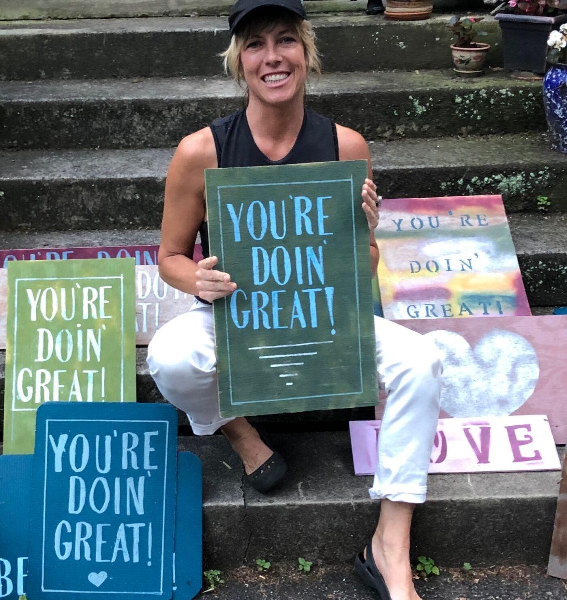 Elle Erickson with various signs created for Bliss Mobs.