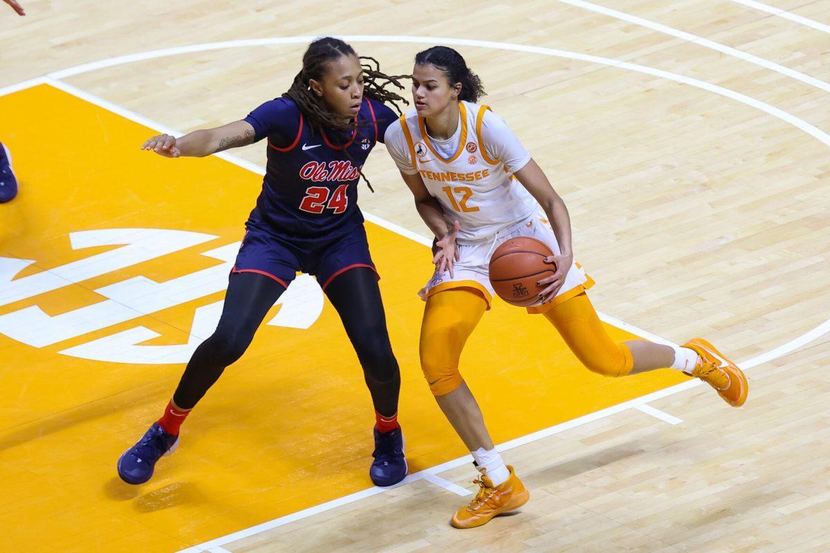 Jan 28, 2021; Knoxville, Tennessee, USA; Tennessee Lady Vols guard Rae Burrell (12) moves the ball against Ole Miss Rebels forward Madison Scott (24) during the first half at Thompson-Boling Arena. Mandatory Credit: Randy Sartin-USA TODAY Sports