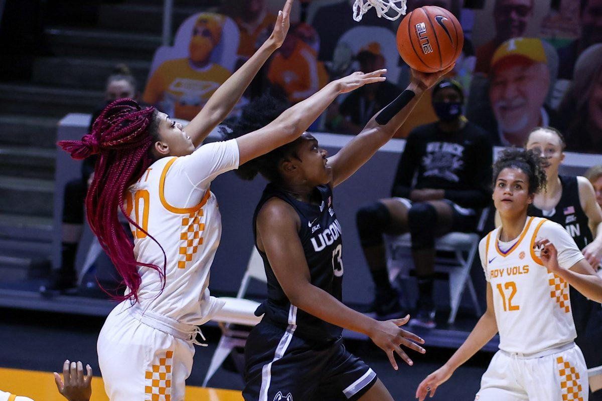 Jan 21, 2021; Knoxville, Tennessee, USA; UConn Huskies guard Christyn Williams (13) goes to the basket against Tennessee Lady Vols center Tamari Key (20) during the second half at Thompson-Boling Arena. Mandatory Credit: Randy Sartin-USA TODAY Sports