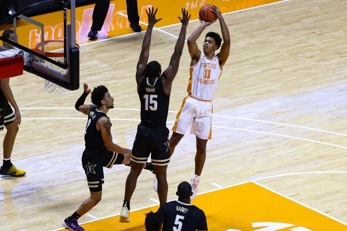 Jan 16, 2021; Knoxville, Tennessee, USA; Tennessee Volunteers guard Jaden Springer (11) shoots the ball against Vanderbilt Commodores forward Clevon Brown (15) during the first half at Thompson-Boling Arena. Mandatory Credit: Randy Sartin-USA TODAY Sports