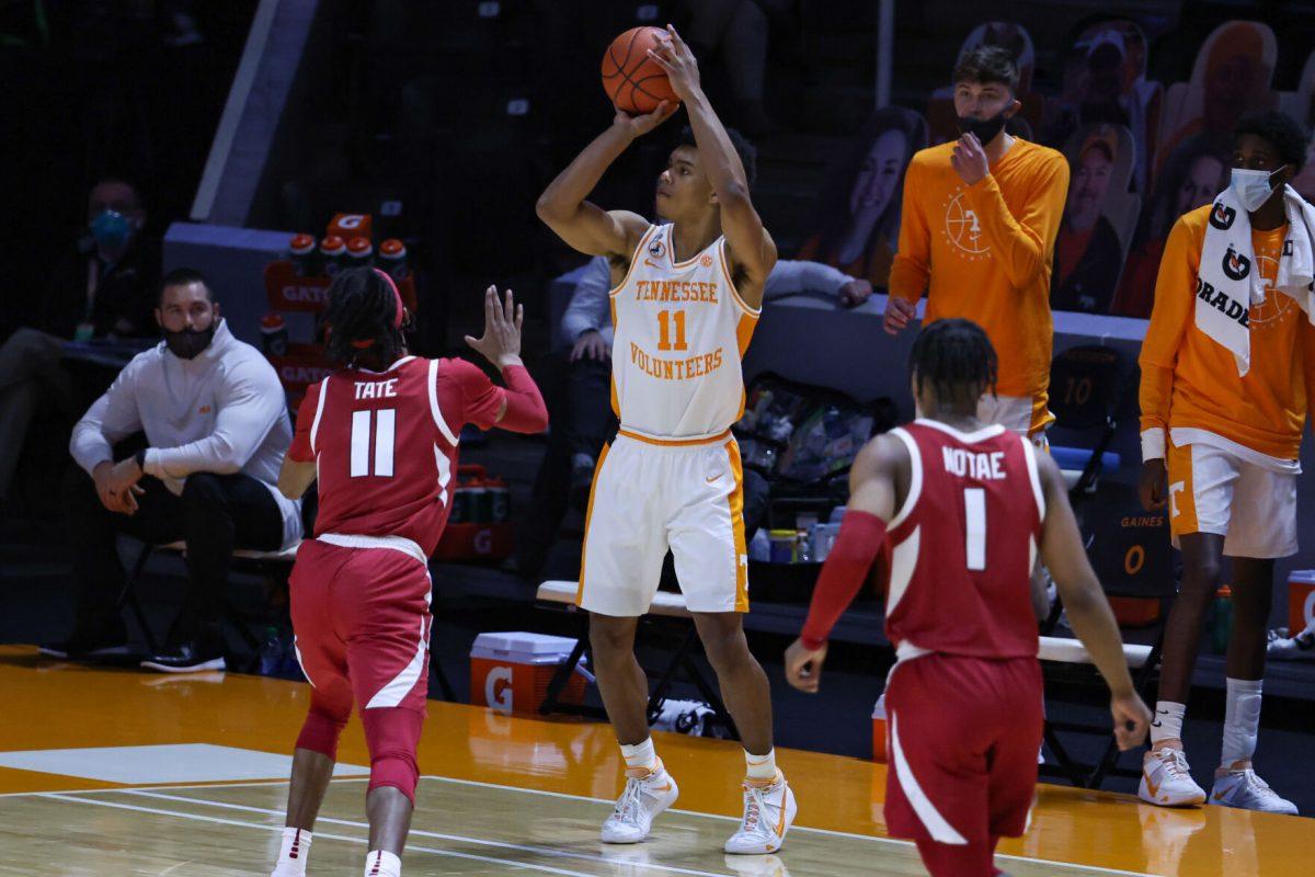 Jan 6, 2021; Knoxville, Tennessee, USA; Tennessee Volunteers guard Jaden Springer (11) shoots a three pointer against Arkansas Razorbacks guard Jalen Tate (11) during the second half at Thompson-Boling Arena. Mandatory Credit: Randy Sartin-USA TODAY Sports