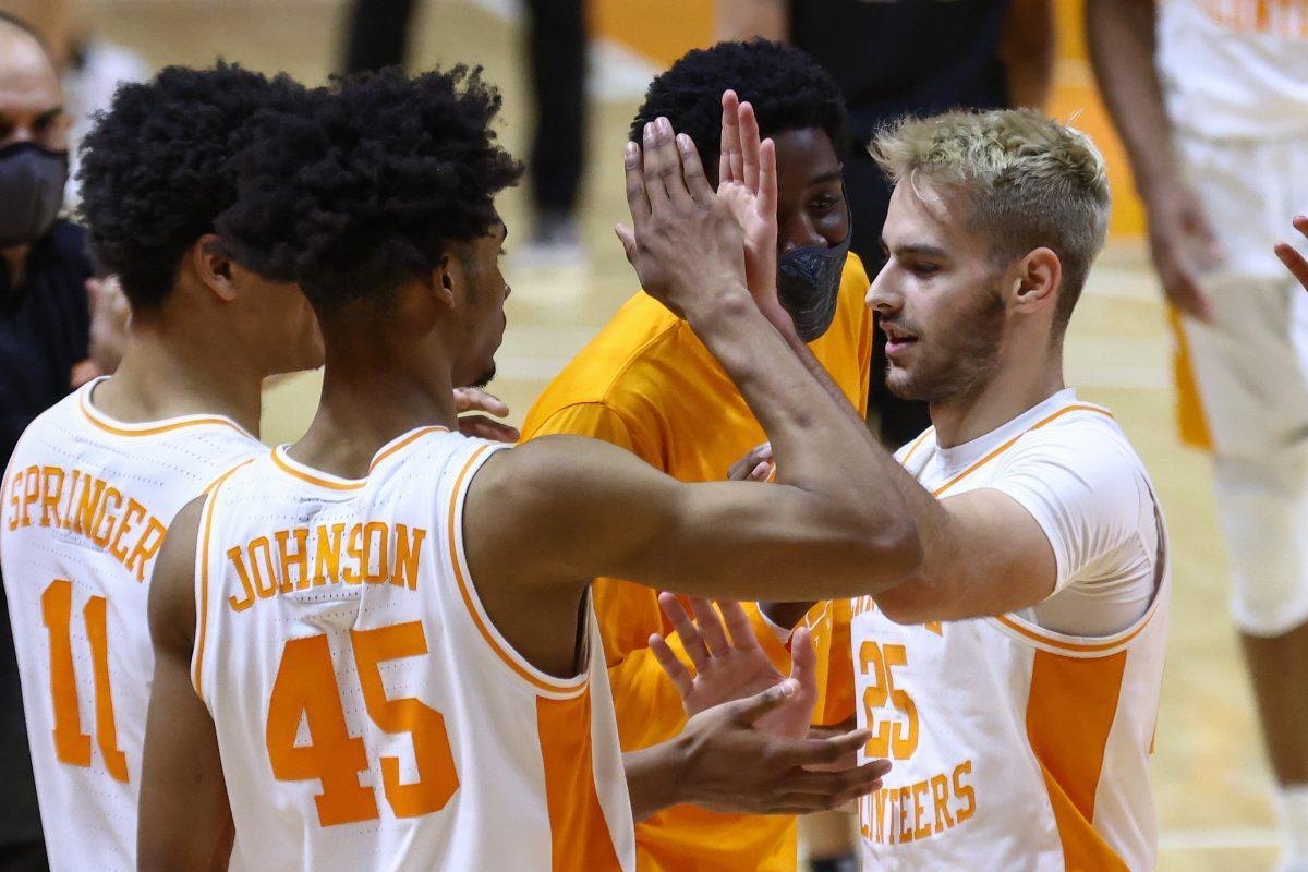 Dec 21, 2020; Knoxville, Tennessee, USA; Tennessee Volunteers guard Jaden Springer (11) and guard Keon Johnson (45) congratulate guard Santiago Vescovi (25) during the second half against the Saint Joseph's Hawks at Thompson-Boling Arena. Mandatory Credit: Randy Sartin-USA TODAY Sports
