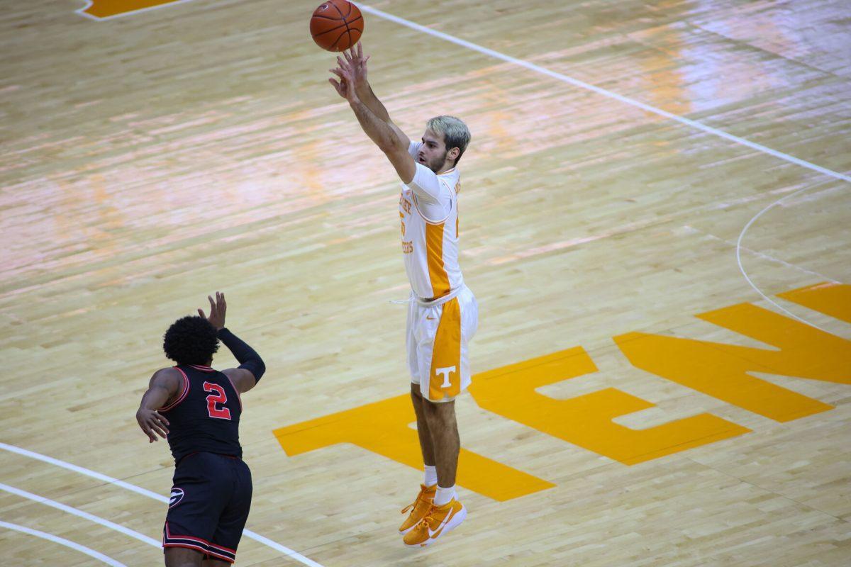 Feb 10, 2021; Knoxville, Tennessee, USA; Tennessee Volunteers guard Santiago Vescovi (25) shoots a three pointer against Georgia Bulldogs guard Sahvir Wheeler (2) during the first half at Thompson-Boling Arena. Mandatory Credit: Randy Sartin-USA TODAY Sports