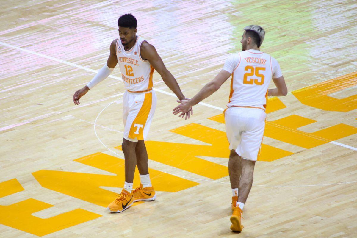 Feb 17, 2021; Knoxville, Tennessee, USA; Tennessee Volunteers guard Victor Bailey Jr. (12) and guard Santiago Vescovi (25) react to a play against the South Carolina Gamecocks during the first half at Thompson-Boling Arena. Mandatory Credit: Randy Sartin-USA TODAY Sports