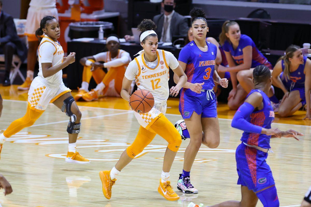 Jan 31, 2021; Knoxville, Tennessee, USA; Tennessee Lady Vols guard Rae Burrell (12) brings the ball up court against Florida Gators guard Lavender Briggs (3) during the first half at Thompson-Boling Arena. Mandatory Credit: Randy Sartin-USA TODAY Sports