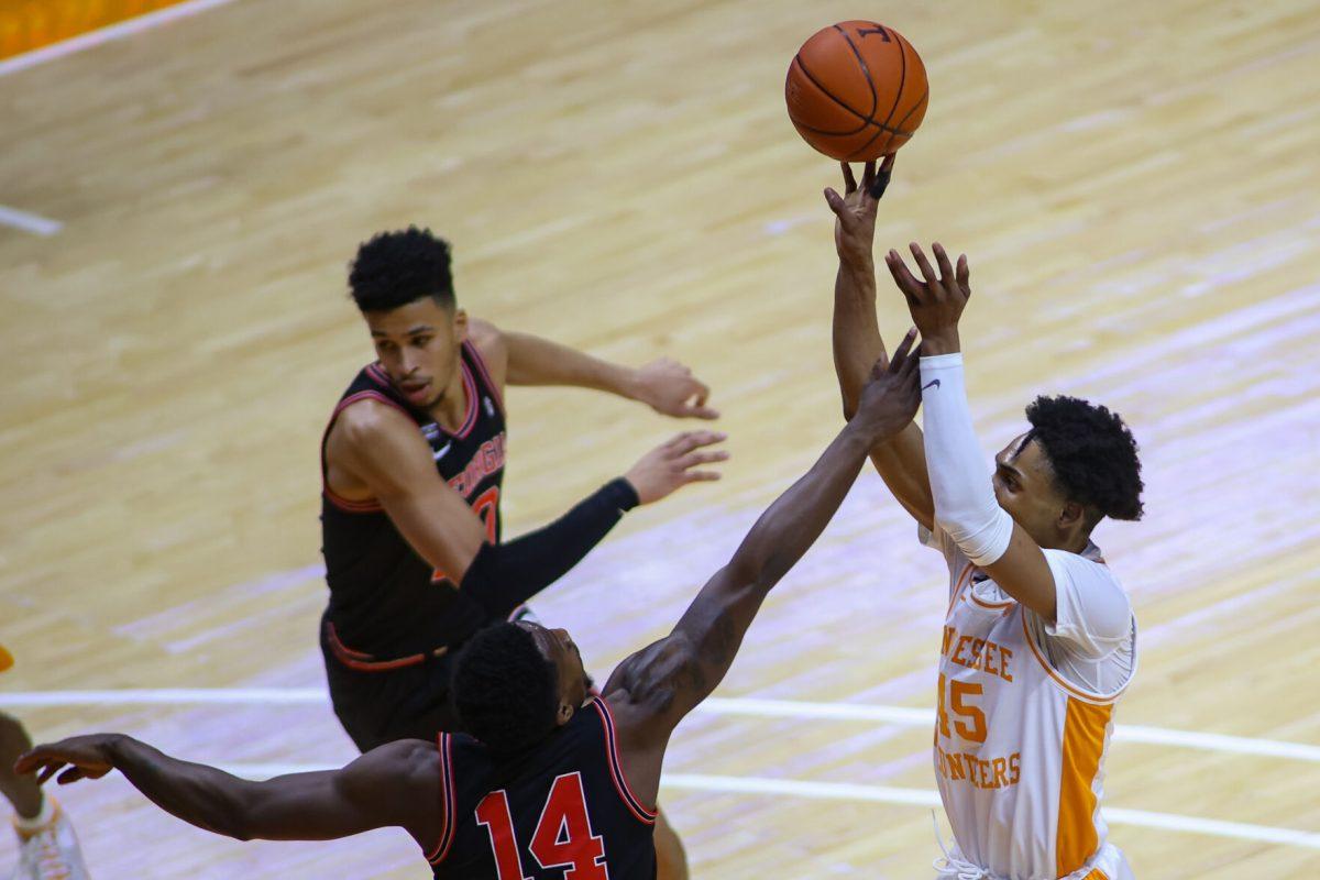 Feb 10, 2021; Knoxville, Tennessee, USA; Tennessee Volunteers guard Keon Johnson (45) shoots the ball against Georgia Bulldogs guard Tye Fagan (14) during the first half at Thompson-Boling Arena. Mandatory Credit: Randy Sartin-USA TODAY Sports