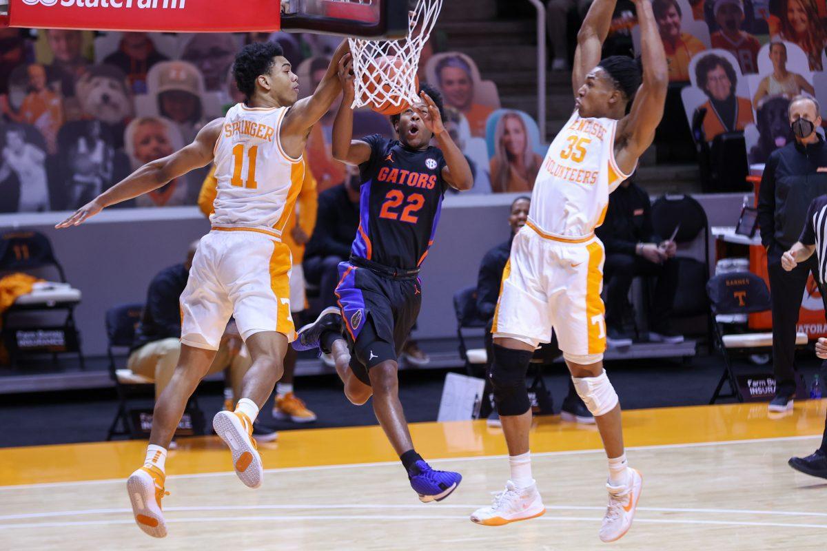 Mar 7, 2021; Knoxville, Tennessee, USA; Florida Gators guard Tyree Appleby (22) goes to the basket against Tennessee Volunteers guard Jaden Springer (11) and guard Yves Pons (35) during the first half at Thompson-Boling Arena. Mandatory Credit: Randy Sartin-USA TODAY Sports