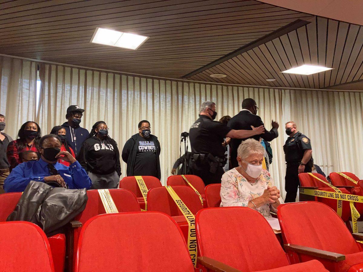 Police begin to clear away protestors at Tuesday's City Council Meeting