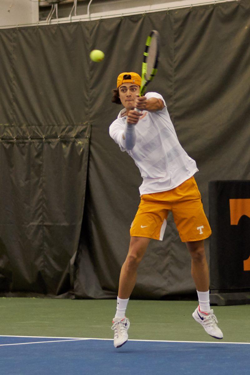 Adam Walton returns a serve during the Men's Tennis opening game against New Mexico, in the Goodfriend Tennis Center on January 18, 2020.