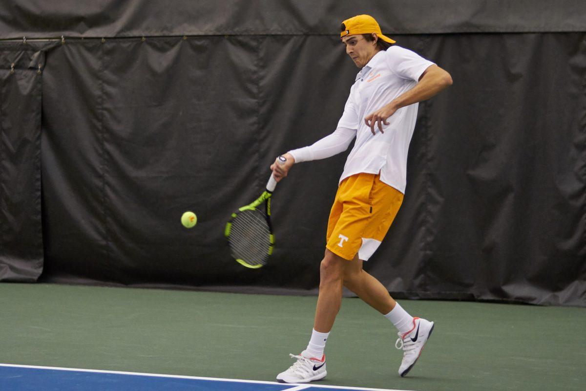 Adam Walton returns a serve during the Men's Tennis opening game against New Mexico, in the Goodfriend Tennis Center on January 18, 2020.