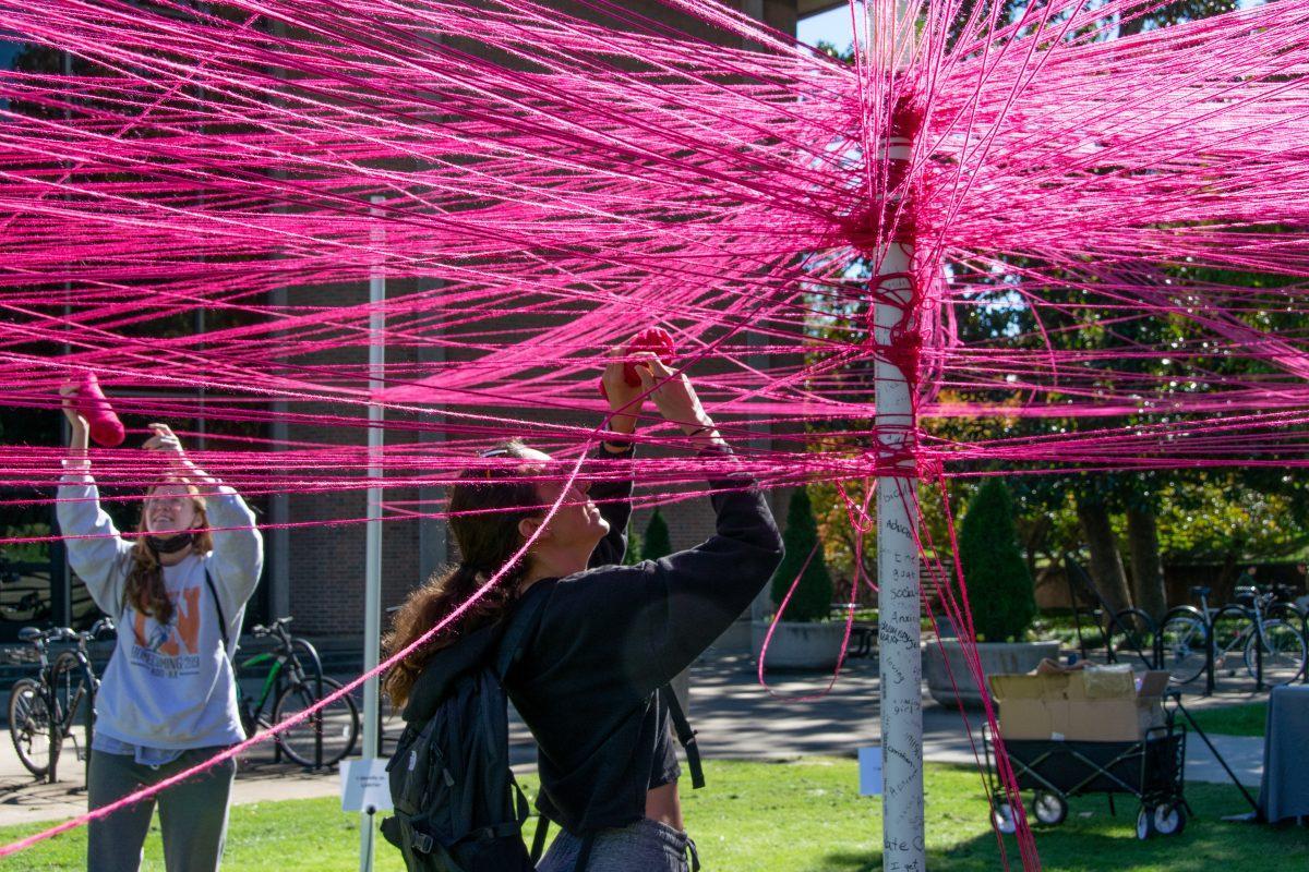 Students weave strings around polls they identify with at The Unity Project event put on by the Student Government Association in HSS Plaza on Wednesday, Oct 27, 2021.