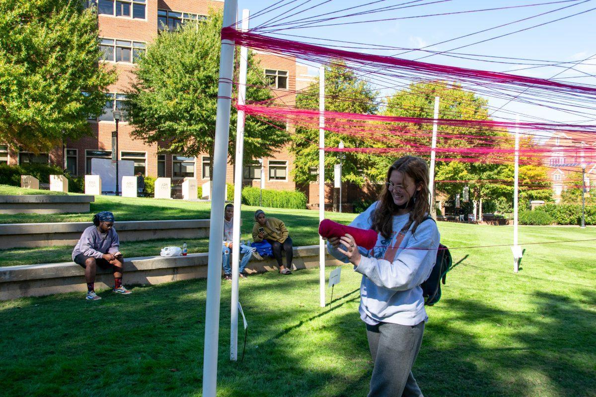 Students weave strings around polls they identify with at The Unity Project event put on by the Student Government Association in HSS Plaza on Wednesday, Oct 27, 2021.