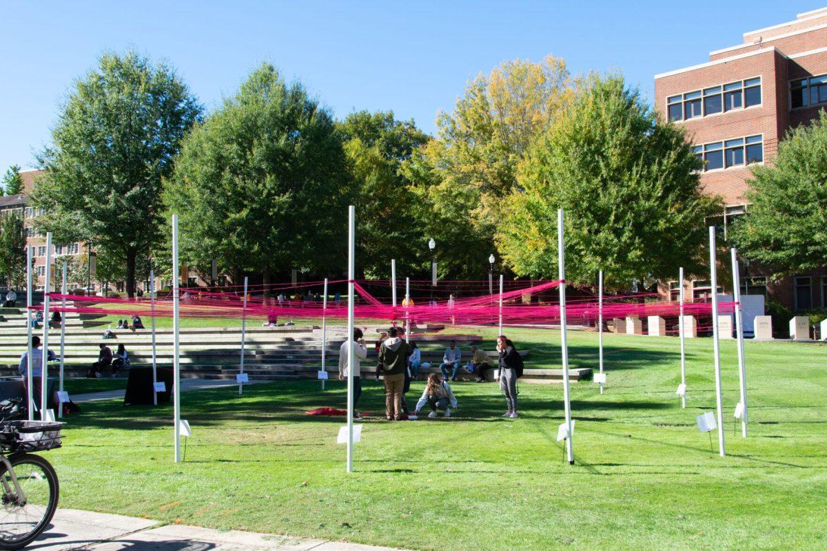 Students weave strings around polls they identify with at The Unity Project event put on by the Student Government Association in HSS Plaza on Wednesday, Oct 27, 2021.