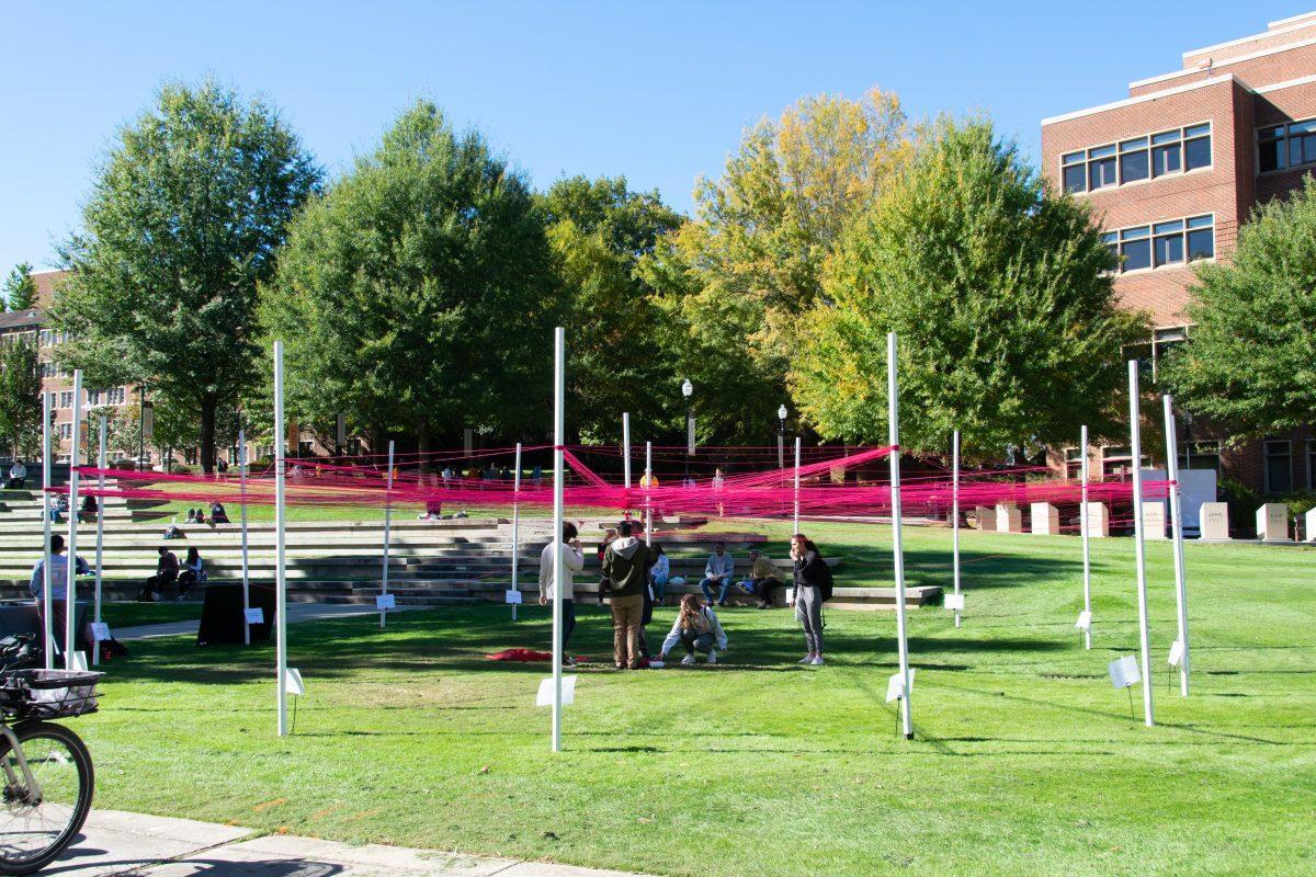 Students weave strings around polls they identify with at The Unity Project event put on by the Student Government Association in HSS Plaza on Wednesday, Oct 27, 2021.