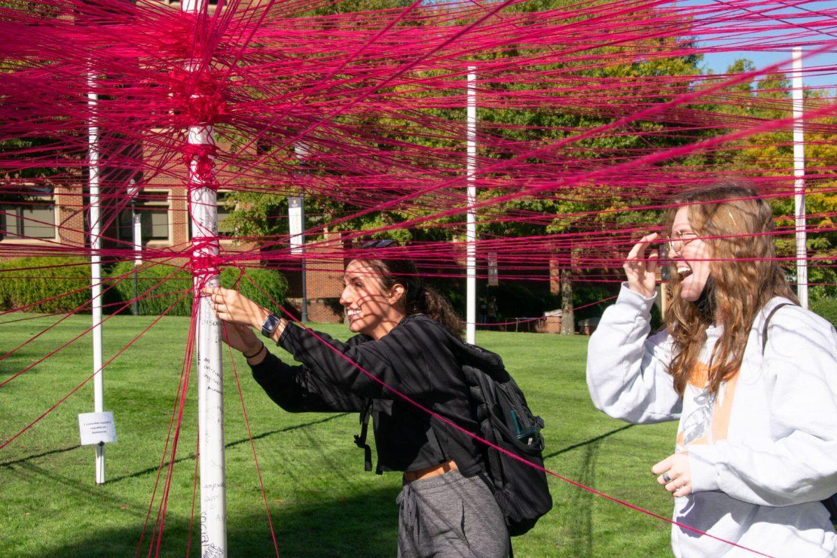 Students weave strings around polls they identify with at The Unity Project event put on by the Student Government Association in HSS Plaza on Wednesday, Oct 27, 2021.