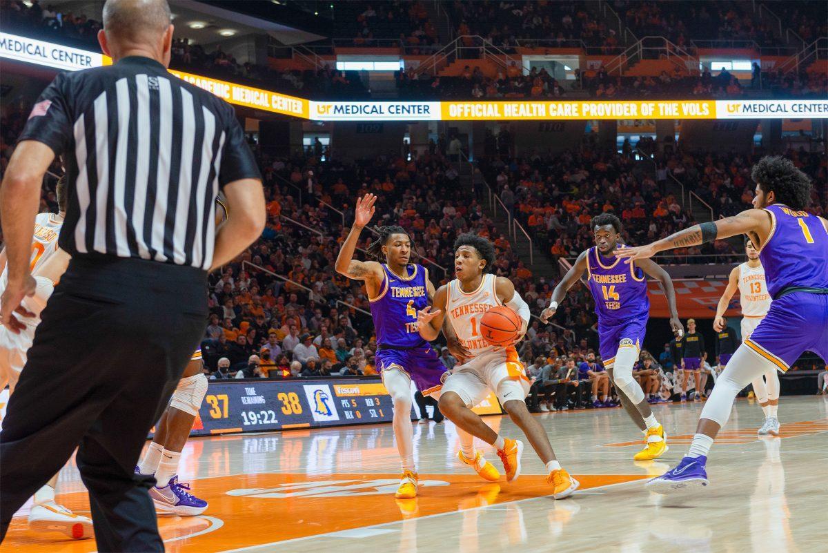 Kennedy Chandler (1) drives to the hoop, defended by Tennessee Tech's Jr. Clay (4) at Thompson Boling Arena on Nov. 26, 2021.