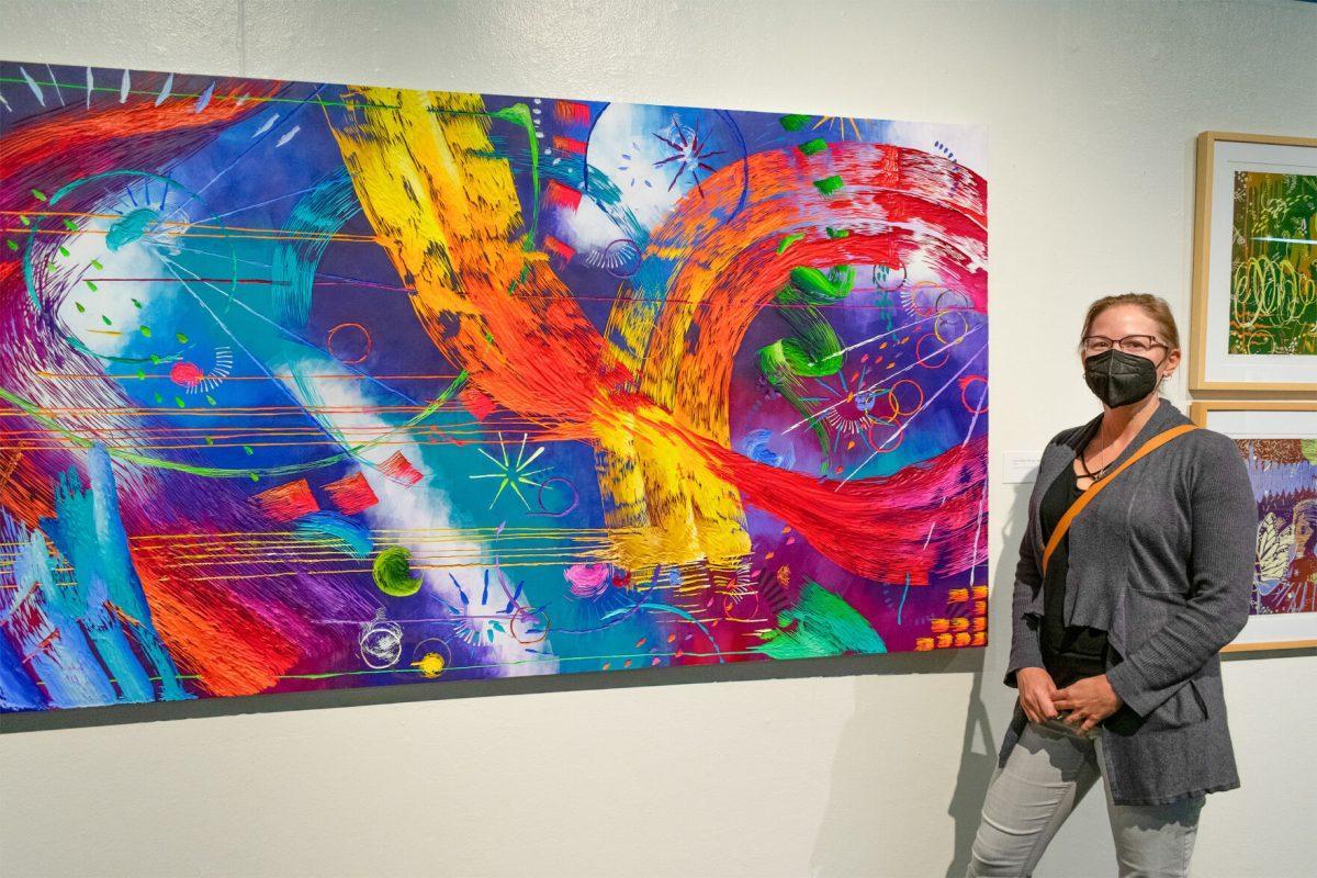 “Carving Brushstrokes”Exhibition by Clinical Assistant Professor Sherry Jankiewicz. Sherry Jankiewicz stands next to her piece "You're Doing it Wrong... Again" At UTK's  Art and Architecture Building, Room 103. November 5, 2021
