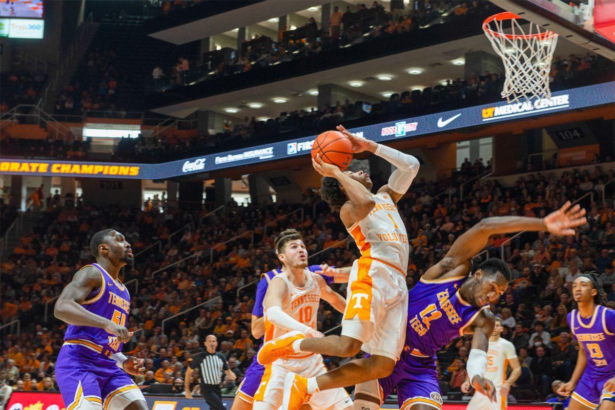 Kennedy Chandler (1) goes to the rim as Tennessee Tech's Amadou Sylla (12) attempts to block him in Thompson Boling Arena on Nov. 26, 2021.