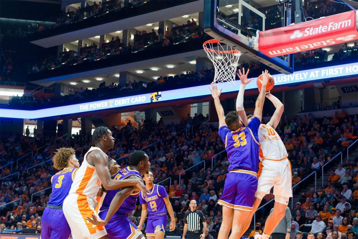John Fulkerson (10) attempts a layup as he's guarded by Tennessee Tech's Shandon Goldman at Thompson Boling Arena on Nov. 26, 2021.