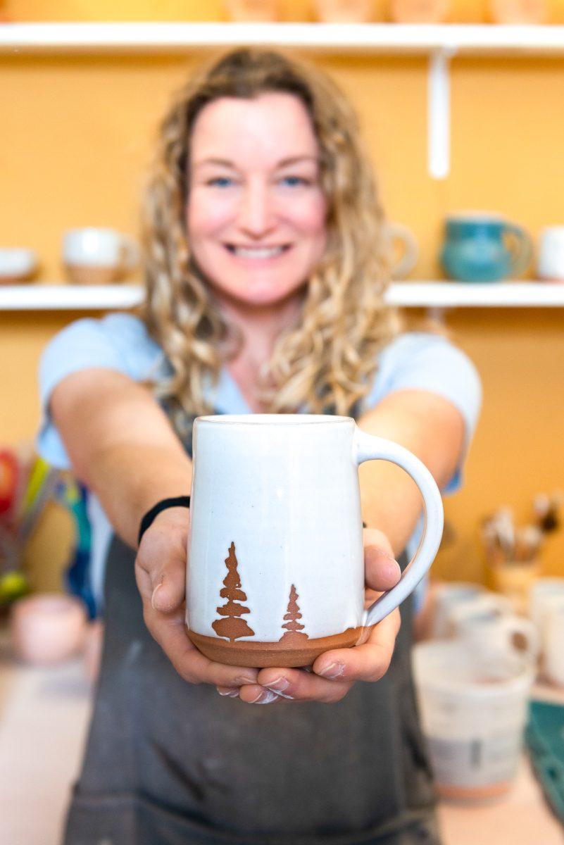 Local clay artist Stacy Shepanek holding a finished piece in her studio at Mighty Mud in Knoxville, TN. Tuesday, Mar 8, 2022.