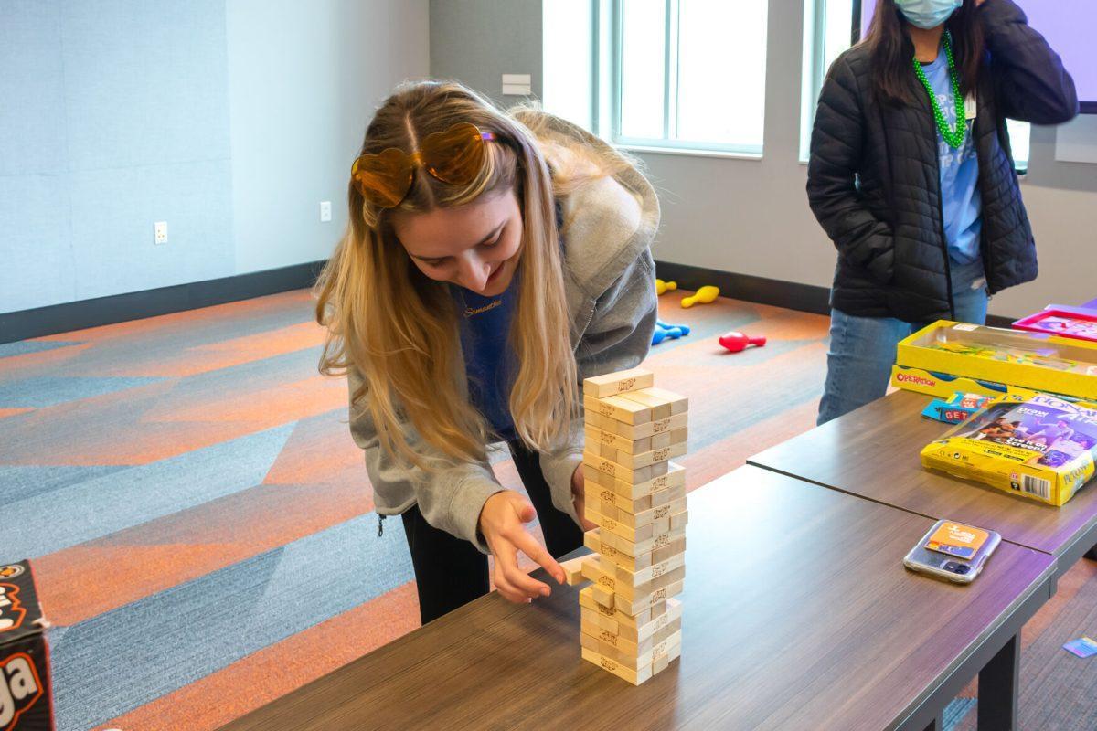 The Volthon game room where Sammi Hurd, student, takes a dance break to play Jenga during the 2022 Volthon event, held in the Student Union on Saturday Feb. 26, 2022.