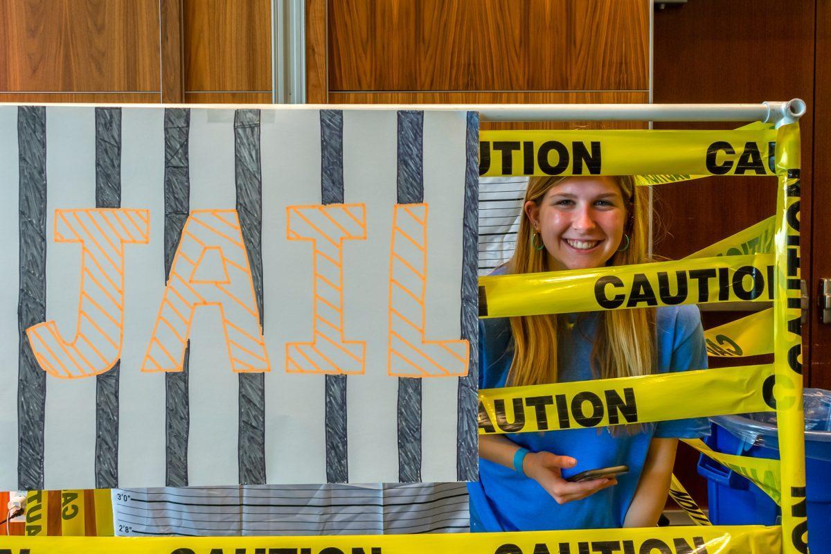 Marybeth Plaster, UT student, smiles from the Volthon Jail in the Student Union during the 2022 Volthon event. Saturday Feb. 26, 2022.