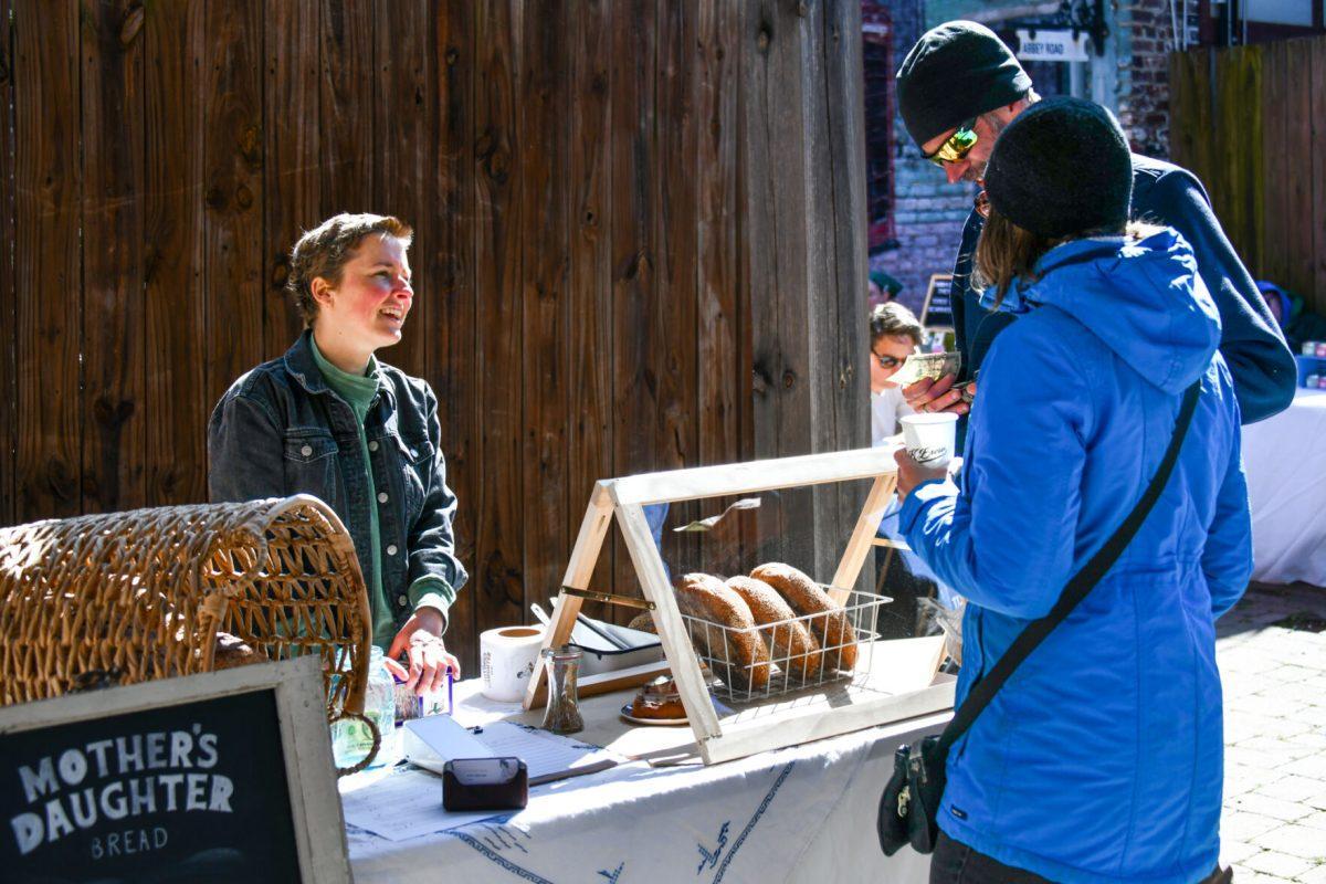 Meade Armstrong, owner of Mother's Daughter Bread, sells her baked goods to patrons of the Sunday Social Market hosted by Honeymouth. Sunday, Mar. 27, 2022.