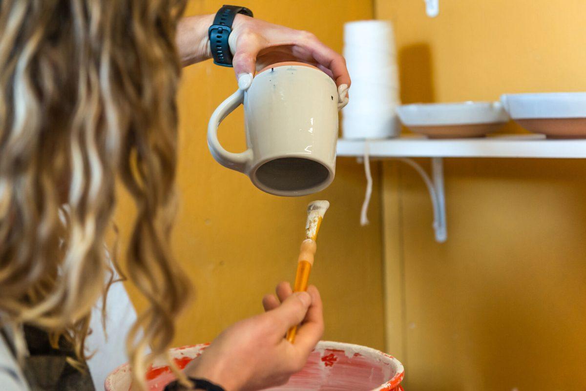 Local clay artist Stacy Shepanek glazing some pieces in her studio at Mighty Mud in Knoxville, TN. Tuesday, Mar 8, 2022.