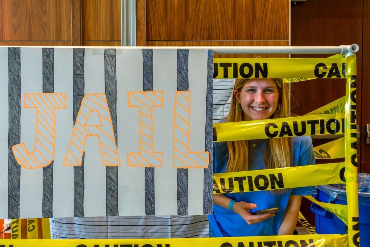 Marybeth Plaster, UT student, smiles from the Volthon Jail in the Student Union during the 2022 Volthon event. Saturday Feb. 26, 2022.