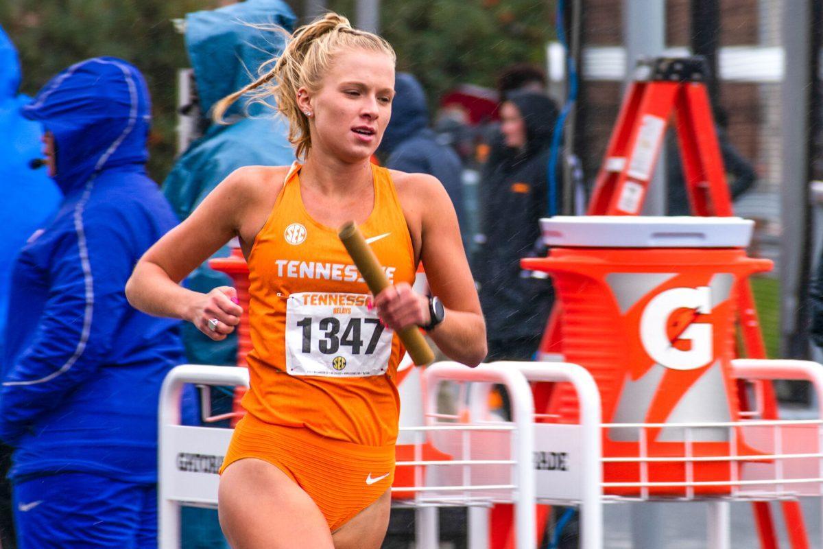 Tennessee's Ainsley Cooper runs the women's 4x1500 meter relay at the Tennessee Relays as the rain and snow began to fall. At Tom Black Track, Saturday, Apr. 9, 2022.