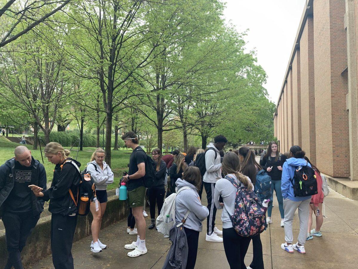 Students and instructors wait outside the Humanities and Social Sciences building for an emergency alarm to end on April 18, 2022. UTPD says the alarm was an accident.