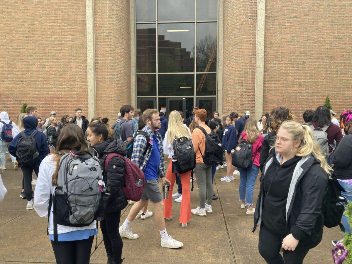 Students and instructors wait outside the Humanities and Social Sciences building for an emergency alarm to end on April 18, 2022. UTPD says the alarm was an accident.
