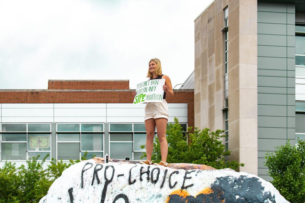 Erin Gwydir, a first-year political science major who led the independently organized protest against the leaked Supreme Court opinion, stands on the Rock on May 8, 2022. 