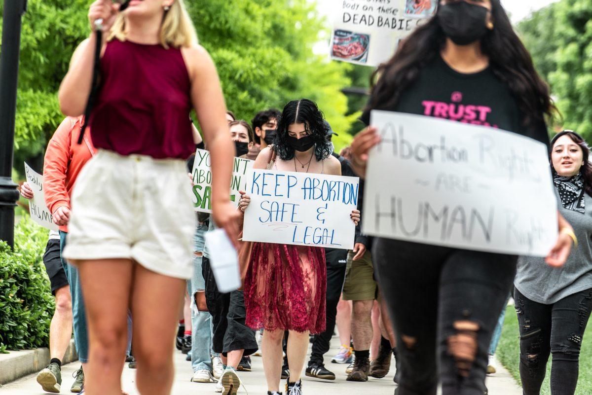 Students, including one anti-abortion rights counter protestor, march from the Rock to the HSS amphitheater on May 8, 2022 in protest of the leaked Supreme Court opinion draft which would overrule Roe v. Wade and trigger abortion bans across the country. 