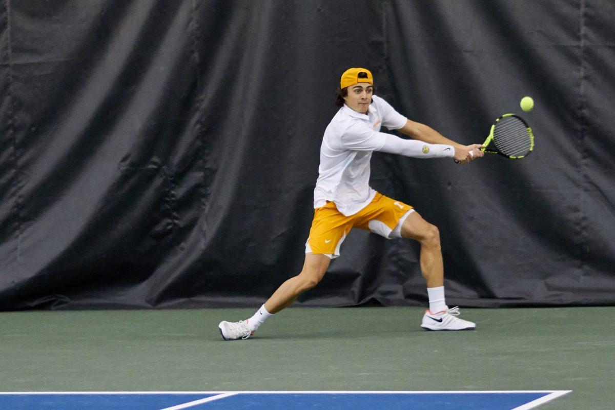 Adam Walton reaches to return a serve during the Men's Tennis opening game against New Mexico, in the Goodfriend Tennis Center on January 18, 2020.