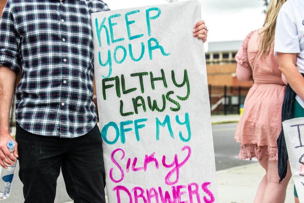 A student holds a sign during a march on May 8, 2022 in protest of the leaked Supreme Court opinion draft which would overrule Roe v. Wade and trigger abortion bans across the country. 