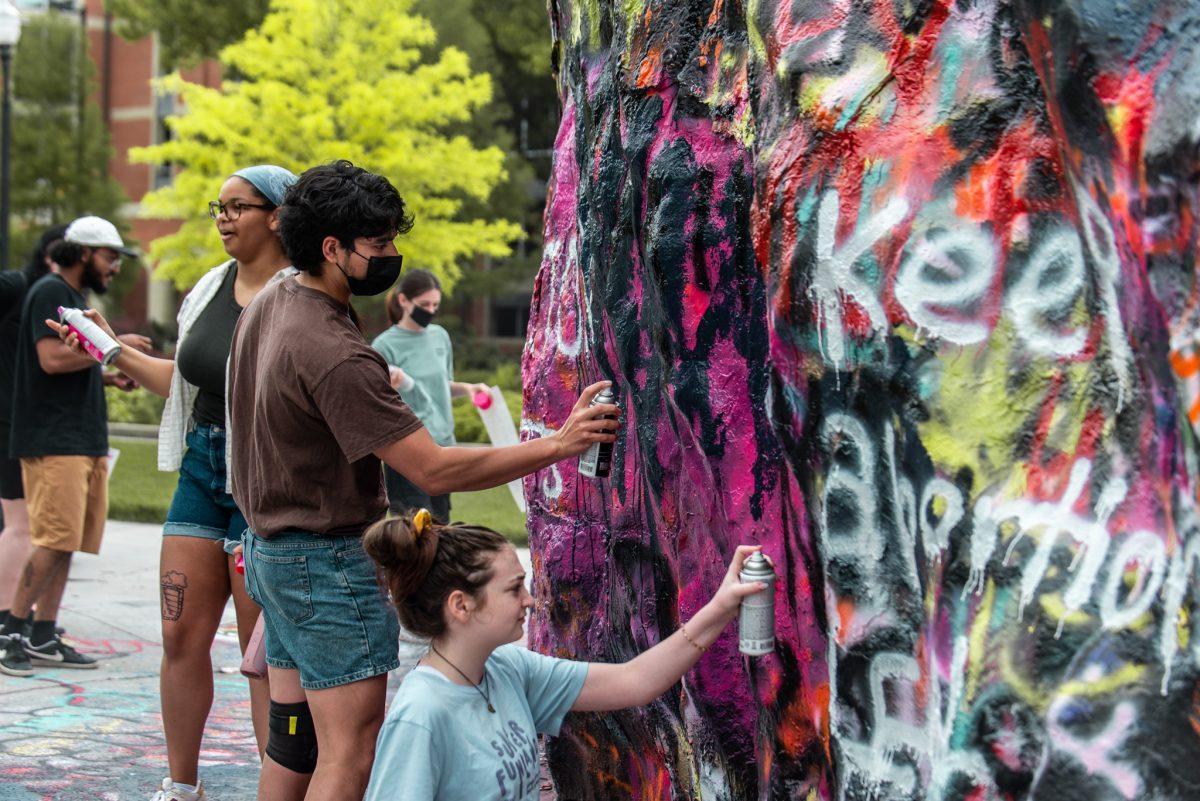 Students paint the Rock with pro-choice slogans during a march on May 8, 2022 in protest of the leaked Supreme Court opinion draft which would overrule Roe v. Wade and trigger abortion bans across the country. 