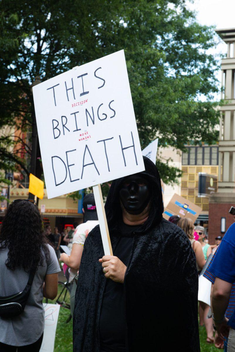 A protestor holds a sign at Krutch Park in protest of the overturning of Roe v. Wade on Friday, June 24, 2022.  