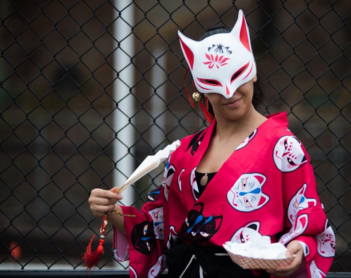 An attendee at the Knoxville Asian Festival dressed in a Japanese kitsune mask and kimono on August 25, 2019 at World's Fair Park. 