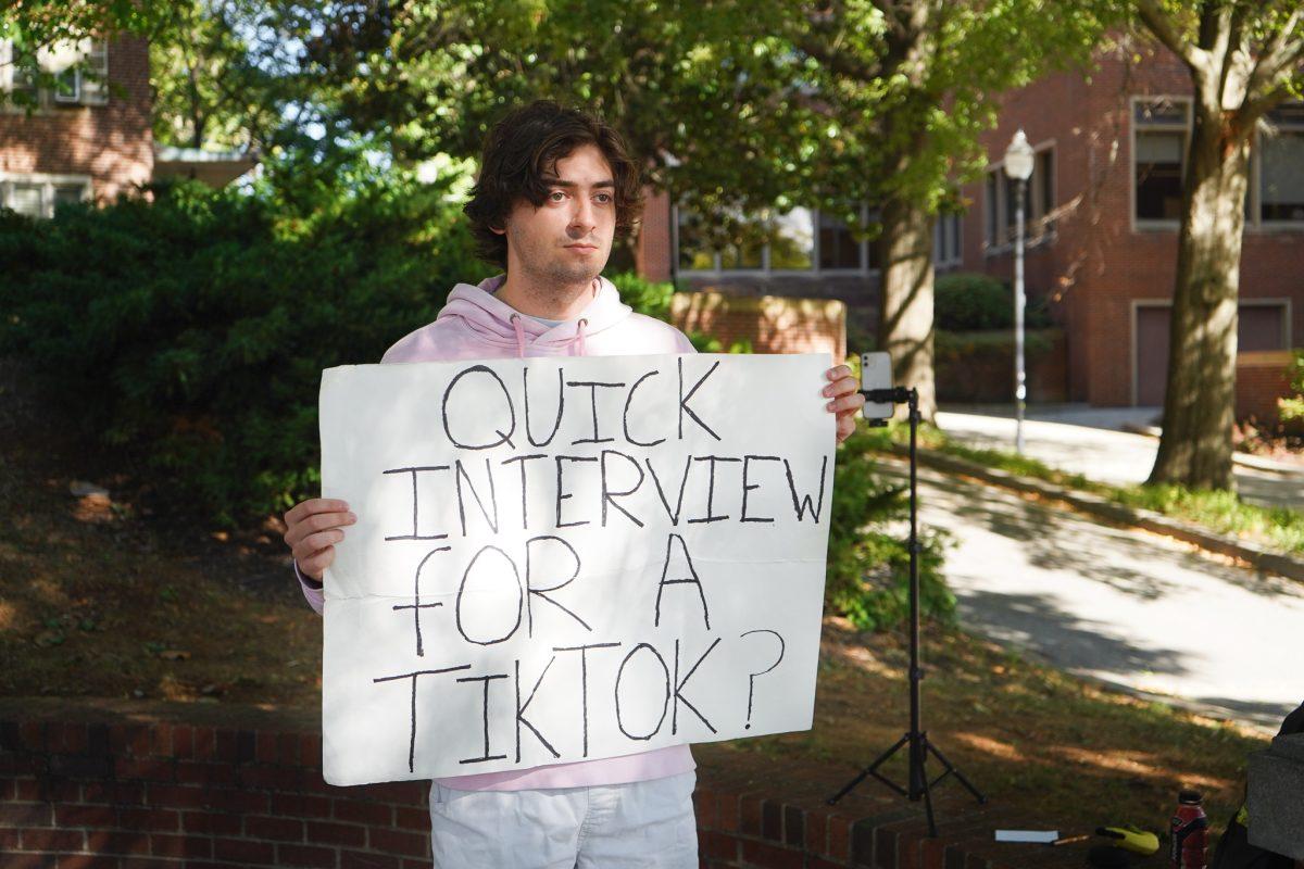 UT Senior Max Thompson interviews passing students for TikTok on the UT Pedestrian Walkway. 