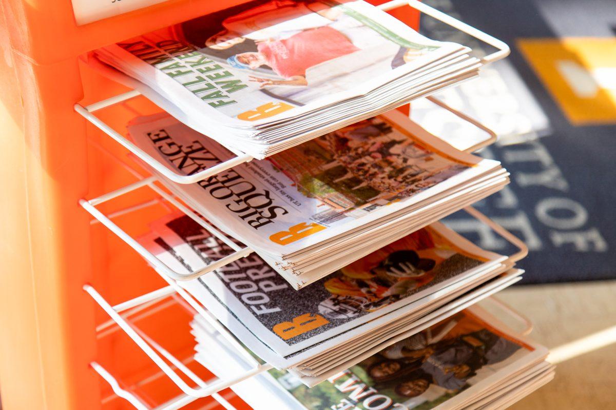 Copies of The Daily Beacon rest on a rack in the main lobby of the Communications and University Extension Building on Sept. 16, 2022. 