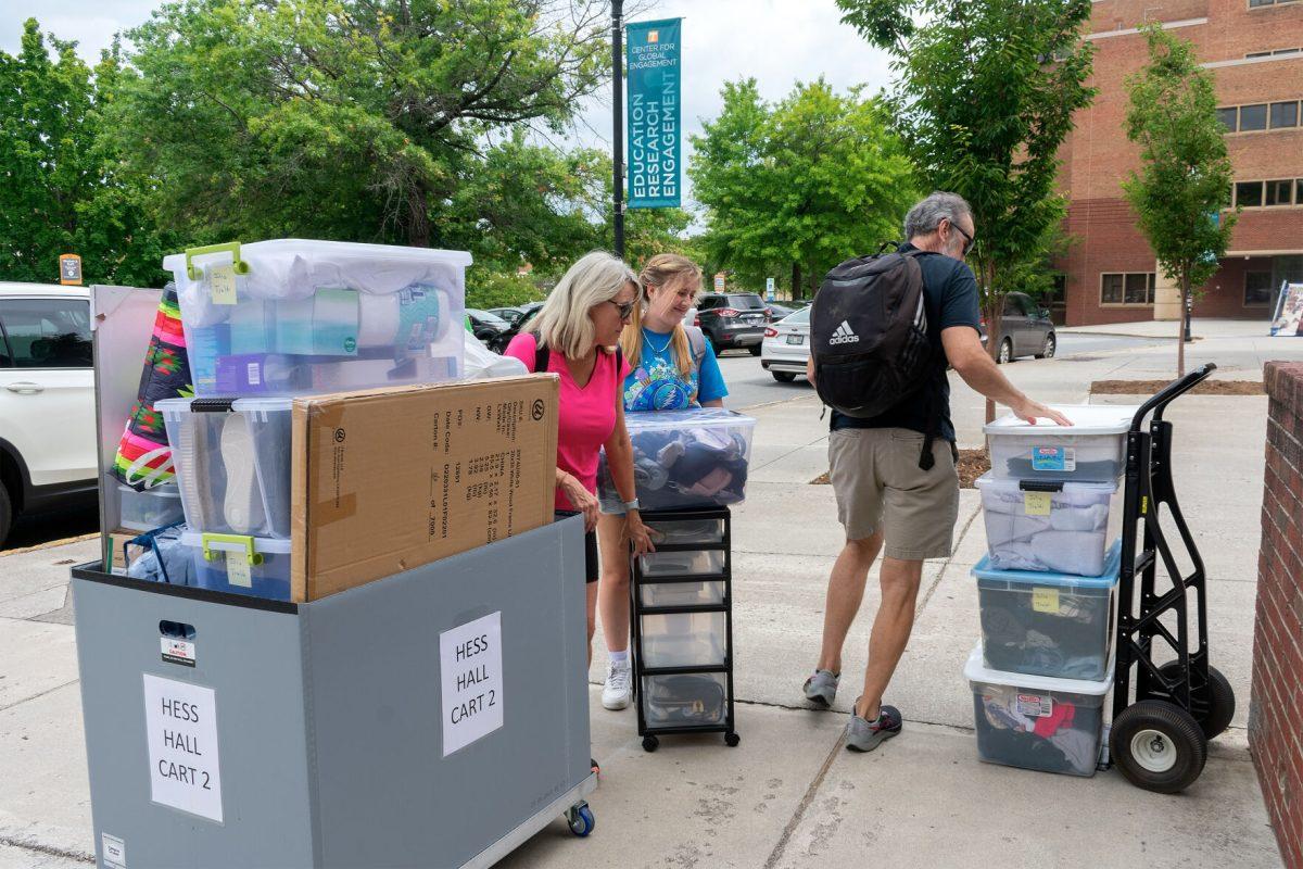 Freshman Julia Traldi (center) and her parents load up her belongings as she gets ready to move into Hess Hall on Aug. 16, 2022.