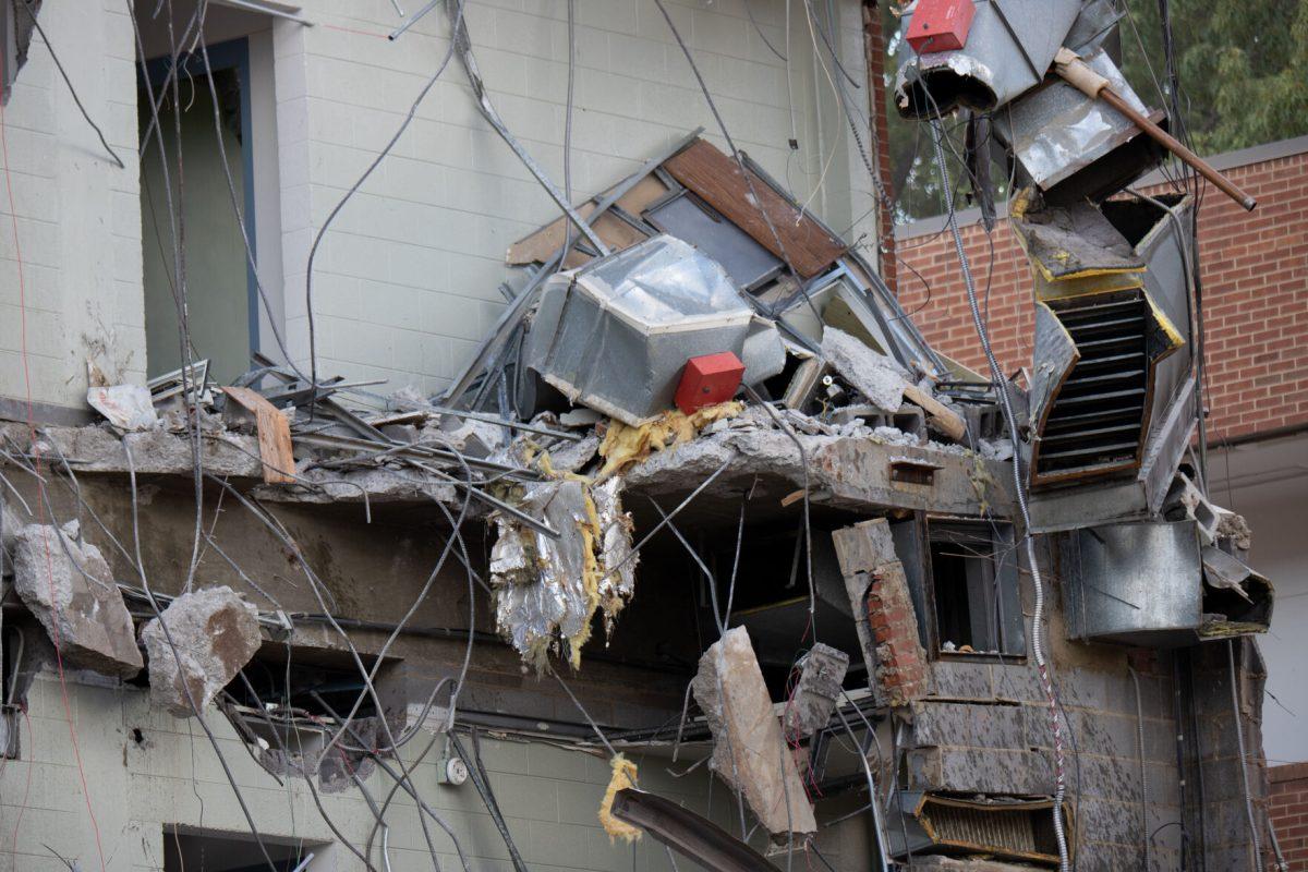 Debris dangles from the open facade of the College of Nursing building, which is set to be replaced by the Croley Nursing Building. Sept. 14, 2022. 