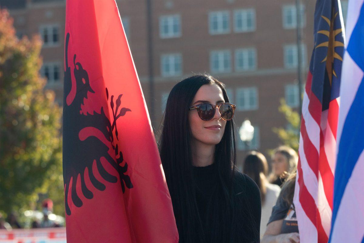 KNOXVILLE, TN - International student Klea Lamallari carries the Albanian Flag in the Homecoming Parade at UT. Friday, Oct. 21, 2022.