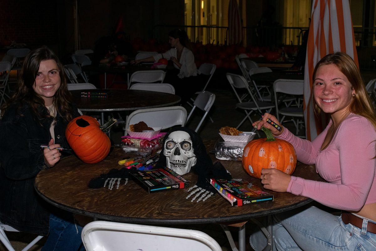 KNOXVILLE, TN - Carson Applegate (left) and Harmony Hartje painting pumpkins at Haunted Campus at the Student Union Plaza. Friday Oct. 28, 2022.