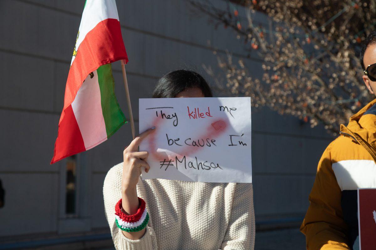 A students holds a sign of solidarity with Iranian students protesting their government on Ped Walkway on Nov. 30, 2022. 